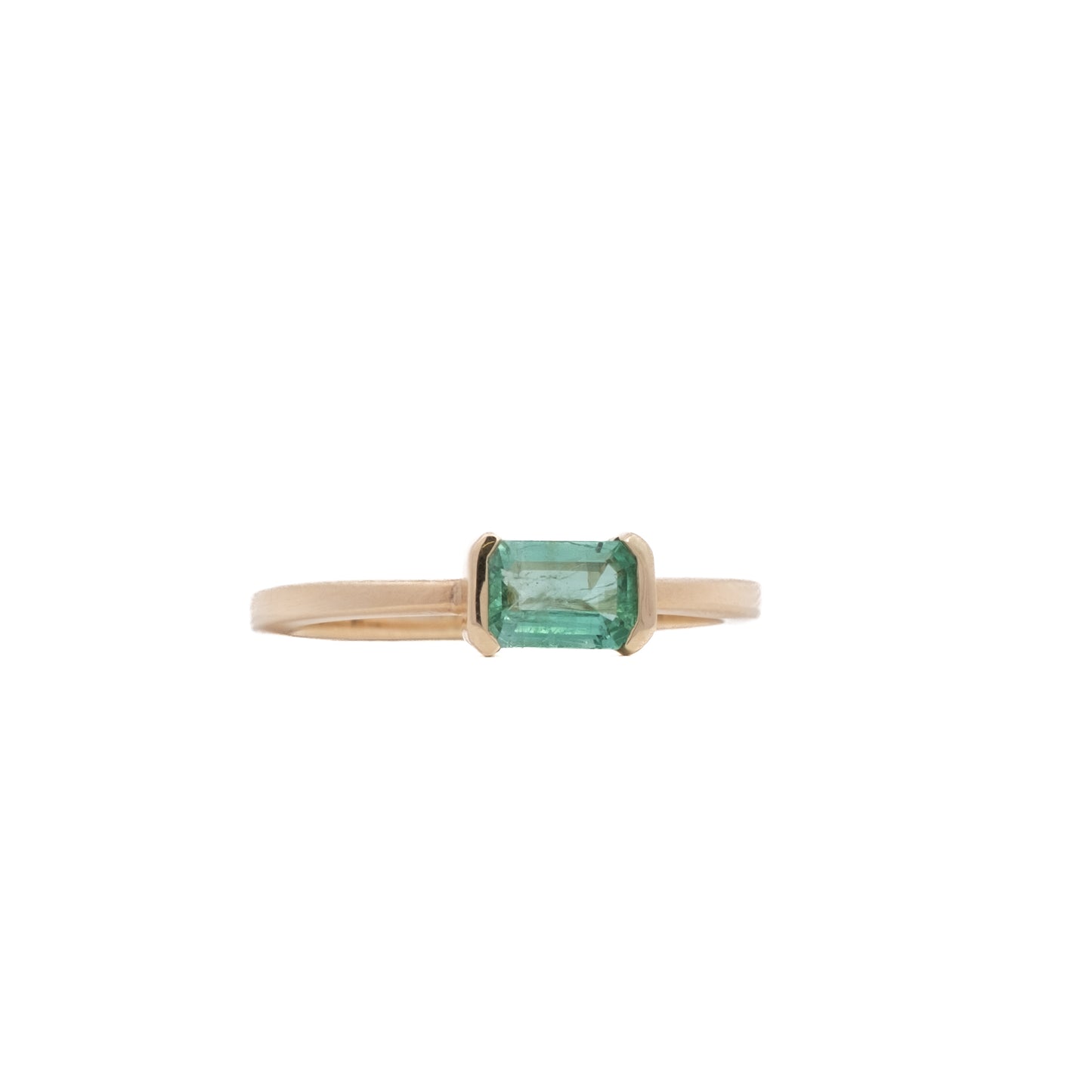 open bezel solitaire ring - natural emerald