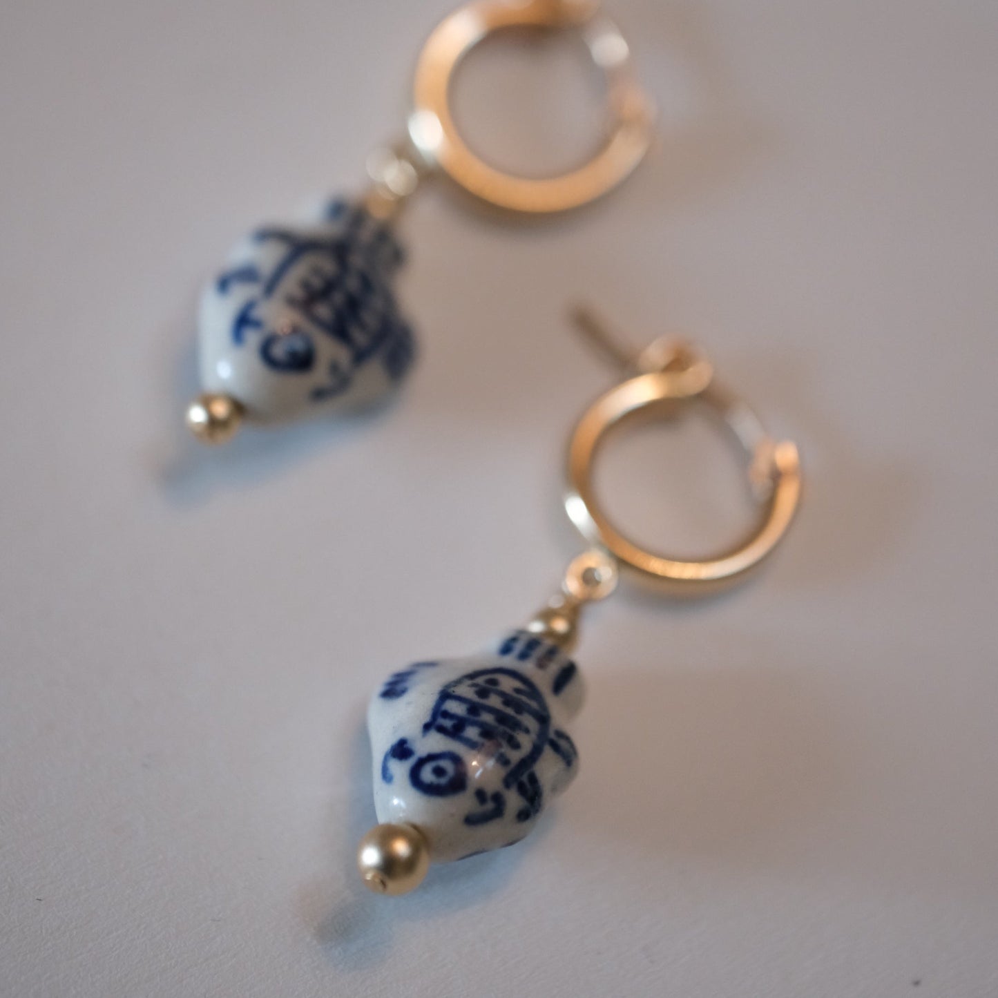 shannon len / ceramic fish tiny tube hoop earrings