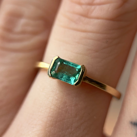 open bezel solitaire ring - natural emerald