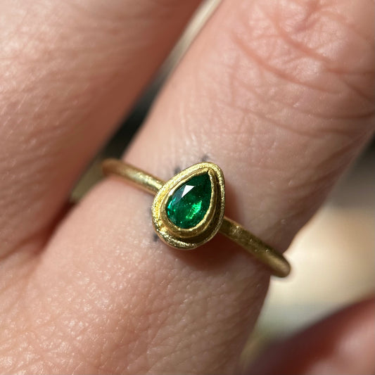 faceted teardrop emerald framed ring
