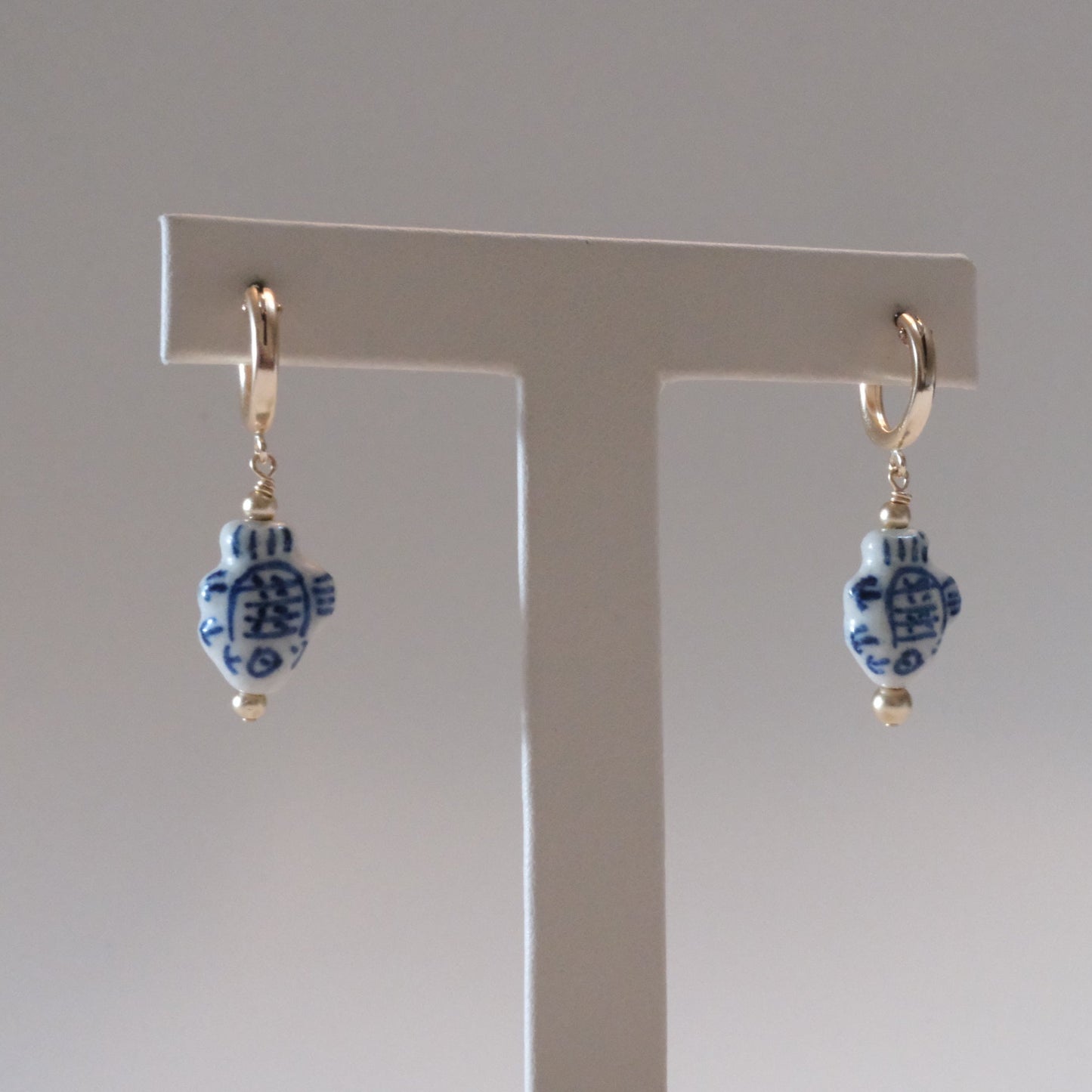 shannon len / ceramic fish tiny tube hoop earrings