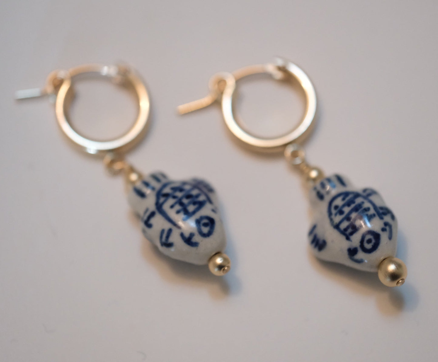 shannon len / ceramic fish tiny tube hoop earrings