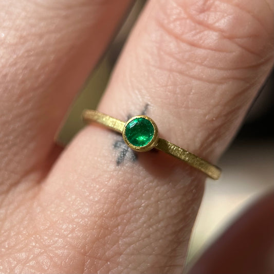faceted round emerald ring